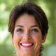 Portrait of Elana Ramirez, a vibrant woman in her late 40s, with a warm, confident smile.