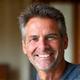Portrait of Mark Johnson, a fit man in his early 50s, with a relaxed, approachable expression.